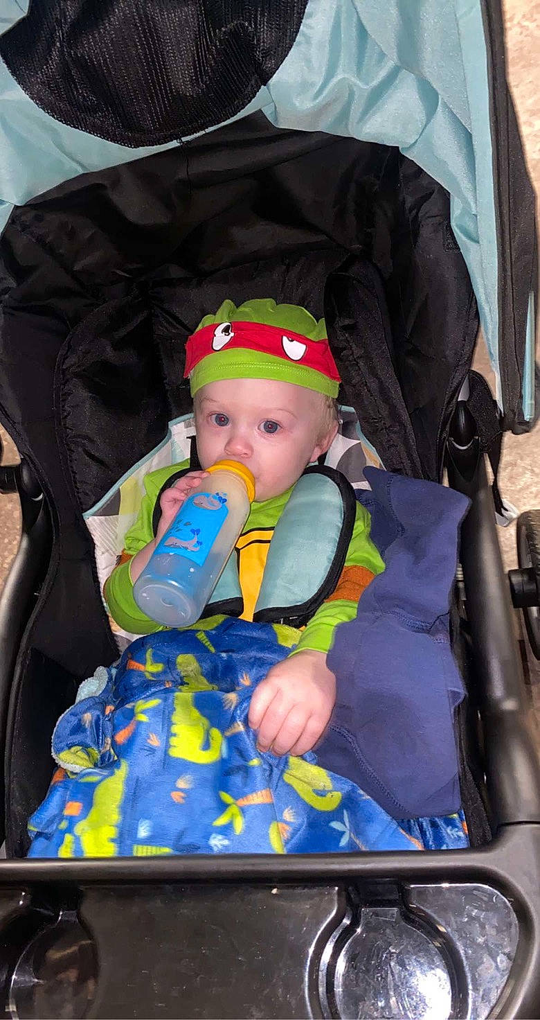 Rowdy is registered to the contest to win money with this photo: baby, baby_carriage, baby_products, baby_safety, baby_toddler_clothing, bag, car_seat, child, comfort, electric_blue, fun, hat, headwear, person, personal_protective_equipment, service, sitting, toddler, vacation