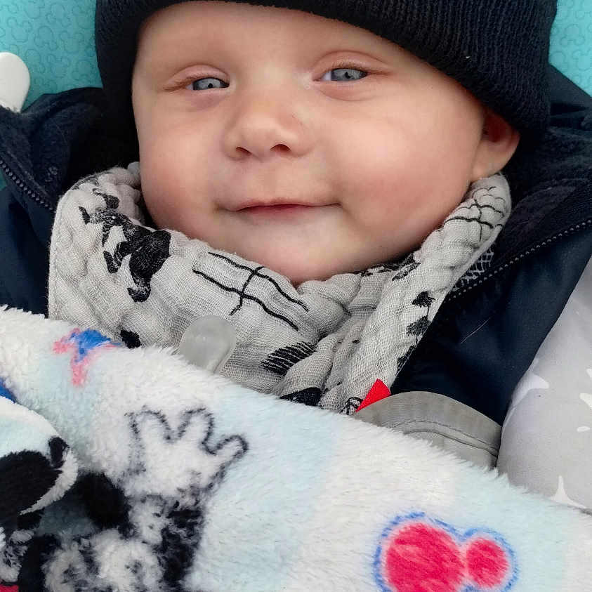 Zayden joined the competition — help win amazing prizes! baby, beanie, blanket, bonnet, cap, clothing, coat, face, glove, happy, hat, head, hood, jacket, knitwear, newborn, person, photography, portrait, smile