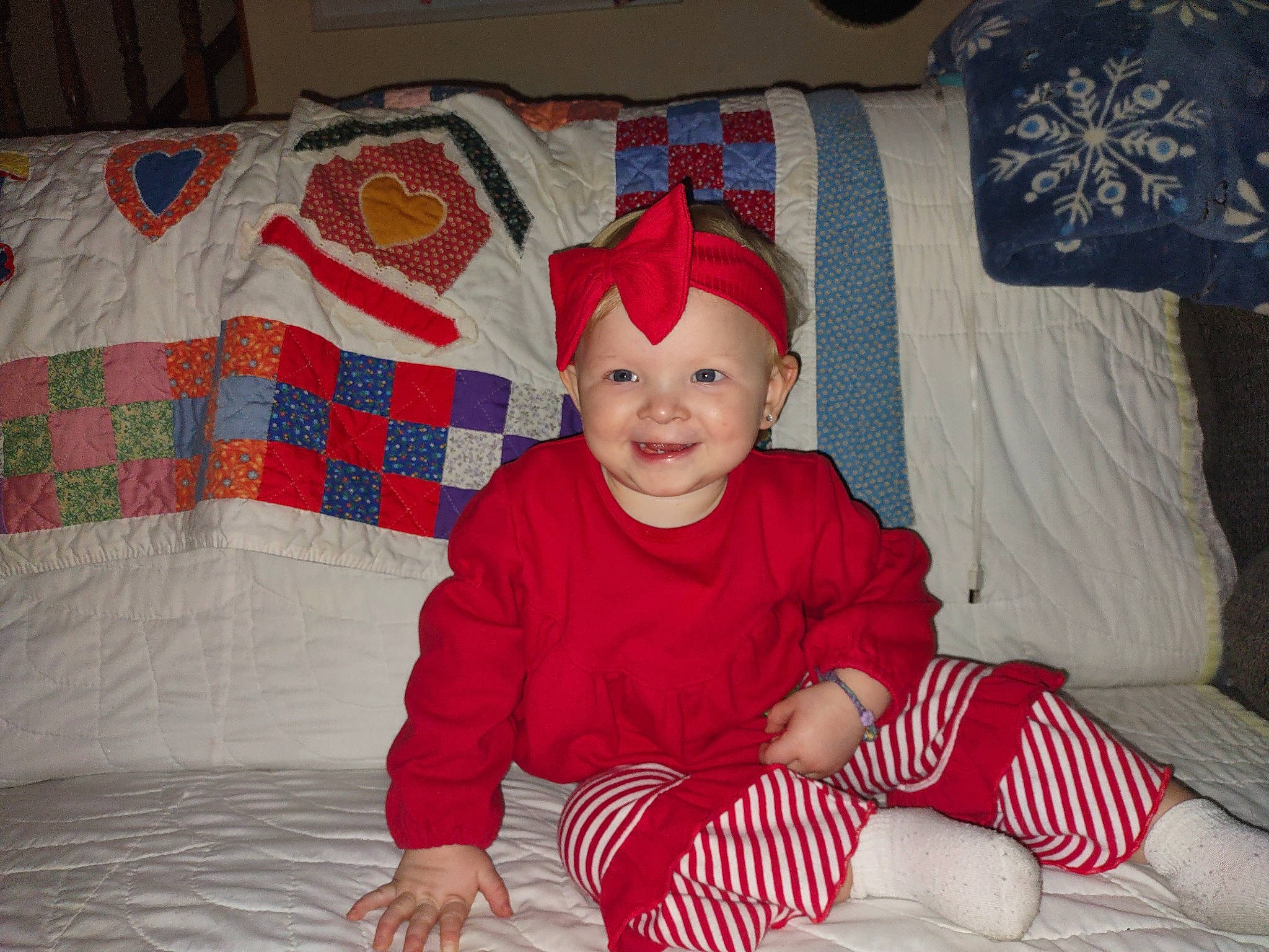 Amaya joined the competition — help win amazing prizes! baby, baby_toddler_clothing, carmine, child, christmas_eve, comfort, event, flooring, fun, happy, headwear, holiday, joy, lap, linens, pattern, person, room, sitting, sleeve
