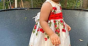 Sofía Ramos joined the competition — help win amazing prizes! toddler, child, dress, floral_dress, trampoline, backyard, greenery, trees, leaves, socks, standing, portrait, outdoor, cute, young_child, person, nature, daylight, curious, photography