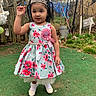Sofía Ramos is registered to the contest to win money with this photo: child, girl, birthday, tiara, dress, floral, outdoor, yard, grass, fence, party, happy, smile, shoes, socks, person, celebration, nature, playful, cute