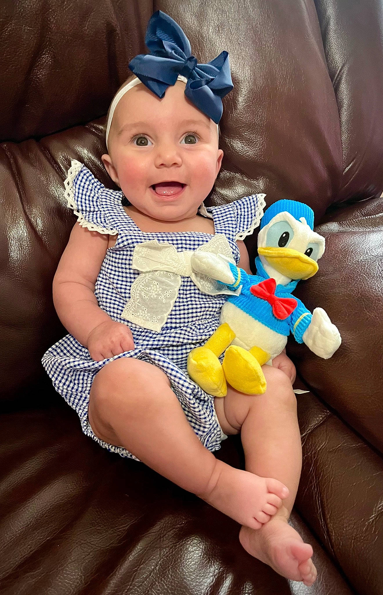 Summer Lee is registered to the contest to win money with this photo: baby, baby_toddler_clothing, cap, child, comfort, finger, fun, hand, happy, headwear, human_body, lap, mammal, person, purple, skin, smile, thigh, thumb, toddler