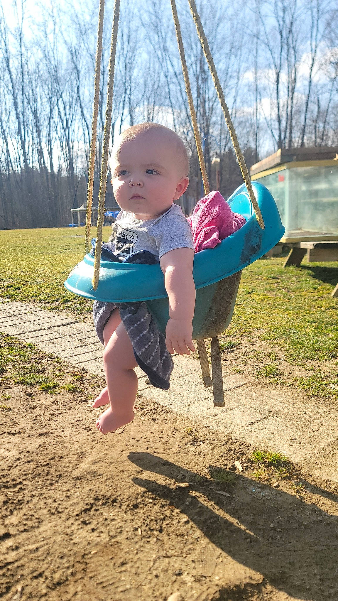 Kace is registered to the contest to win money with this photo: baby, baby_toddler_clothing, child, city, fun, grass, happy, leisure, outdoor_play_equipment, people_in_nature, person, plant, playground, recreation, shade, sitting, sky, soil, swing, toddler