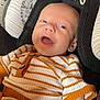 baby, infant, smiling, car_seat, clothing, striped, orange, white, cute, comfort, child, face, head, happy, portrait, seat, soft, cozy, indoors, young