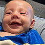 Mathis participe au concours pour gagner de l'argent avec cette photo : baby, child, smiling, blue_shirt, toy, giraffe_toy, indoor, couch, furniture, happy, infant, closeup, person, skin, face, head, arm, comfort, play, home