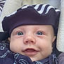 baby, face, blue_eyes, hat, striped_hat, clothing, smile, close_up, infant, cute, soft_blanket, patterned_outfit, child, headwear, portrait, happy, cozy, young_child, wearing, looking