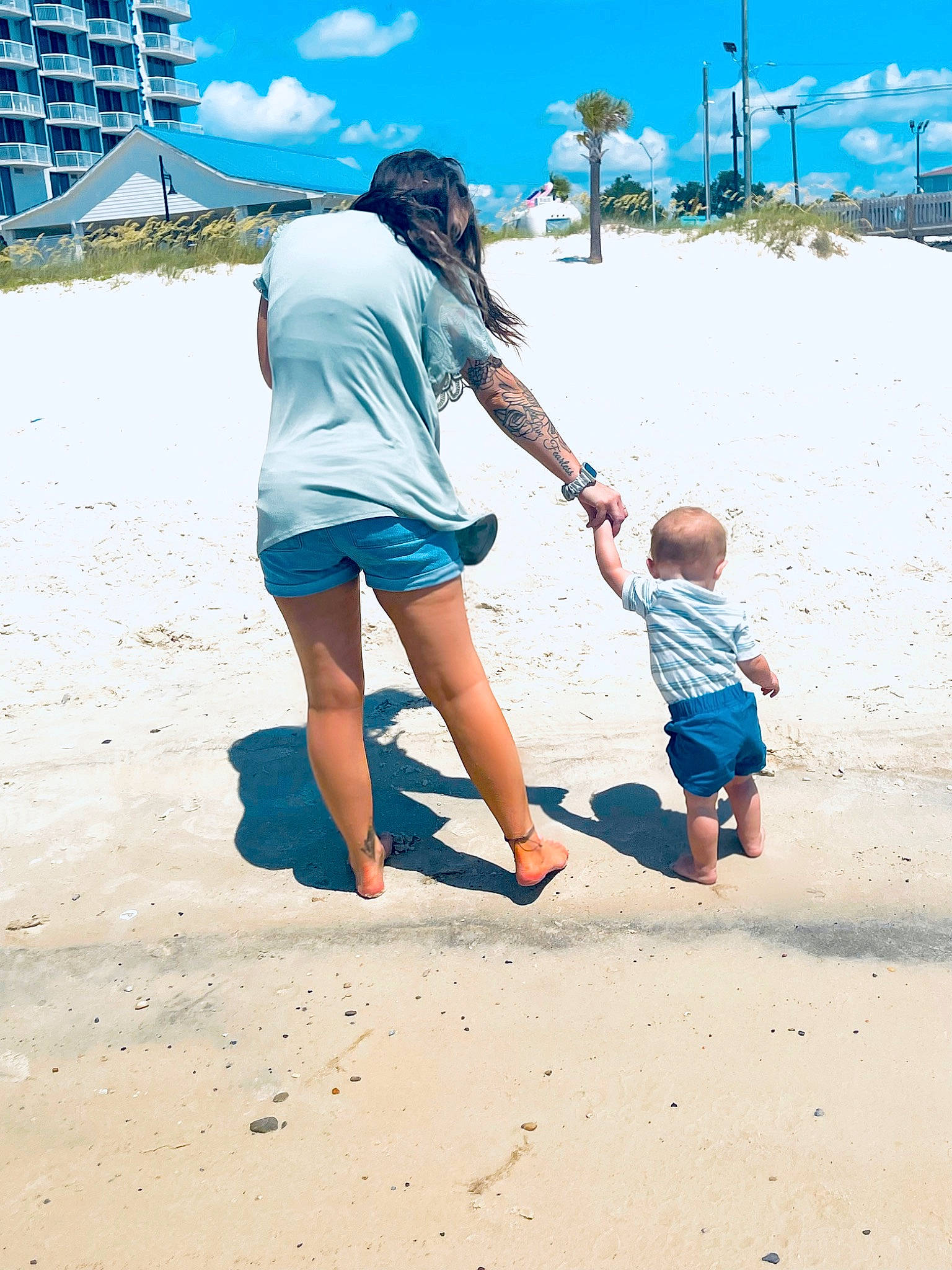 Jaxxon is registered to the contest to win money with this photo: azure, beach, blue, body_of_water, cloud, fun, gesture, happy, leg, leisure, people, people_in_nature, people_on_beach, person, photograph, shorts, sky, summer, t_shirt, toddler