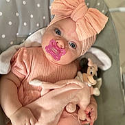 Leyna participe au concours pour gagner de l'argent avec cette photo : baby, pacifier, headband, bow, plush_toy, minnie_mouse, pink_clothing, infant, polka_dot, blanket, cute, child, soft_toy, indoors, portrait, sitting, toddler, hand, face, blue_eyes