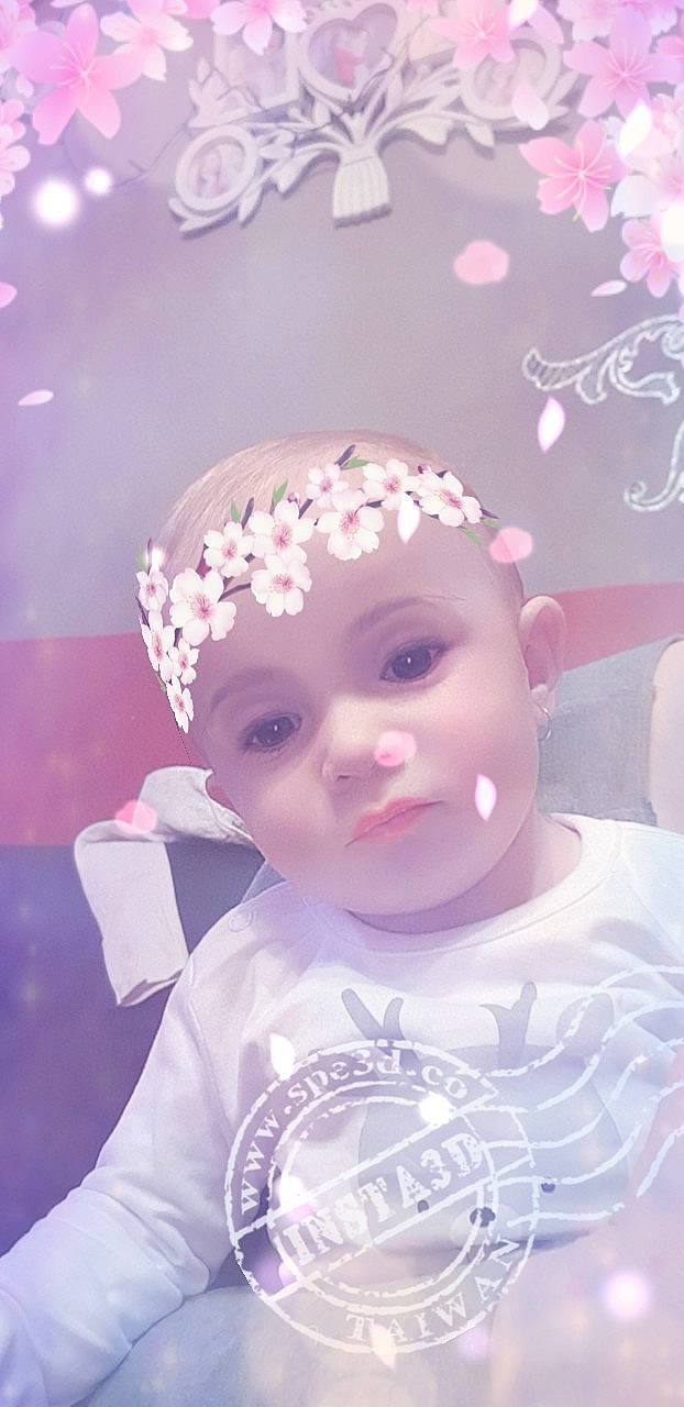 Melody participe au concours pour gagner de l'argent avec cette photo : beauty, cheek, child, close_up, doll, face, flower, girl, hair_accessory, head, headwear, infant, lavender, lilac, person, petal, pink, purple, skin, smile