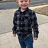 Jaxon is registered to the contest to win money with this photo: child, boy, sidewalk, street, building, brick_building, window, car, jeans, shirt, sneakers, outdoor, casual_clothing, smiling, standing, urban, daytime, person, happy, hair