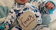 Brayden joined the competition — help win amazing prizes! baby, infant, child, onesie, shark_pattern, blanket, blue, white, wooden_sign, four_months, milestone, cute, smiling, portrait, lying_down, hand, face, eyes, soft_texture, cozy