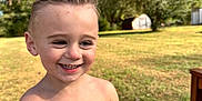 Asher is registered to the contest to win money with this photo: child, boy, smile, outdoor, backyard, grass, trees, sunshine, toddler, shirtless, bubble_bottle, happy, portrait, hands, haircut, playtime, lawn, bench, sitting, person
