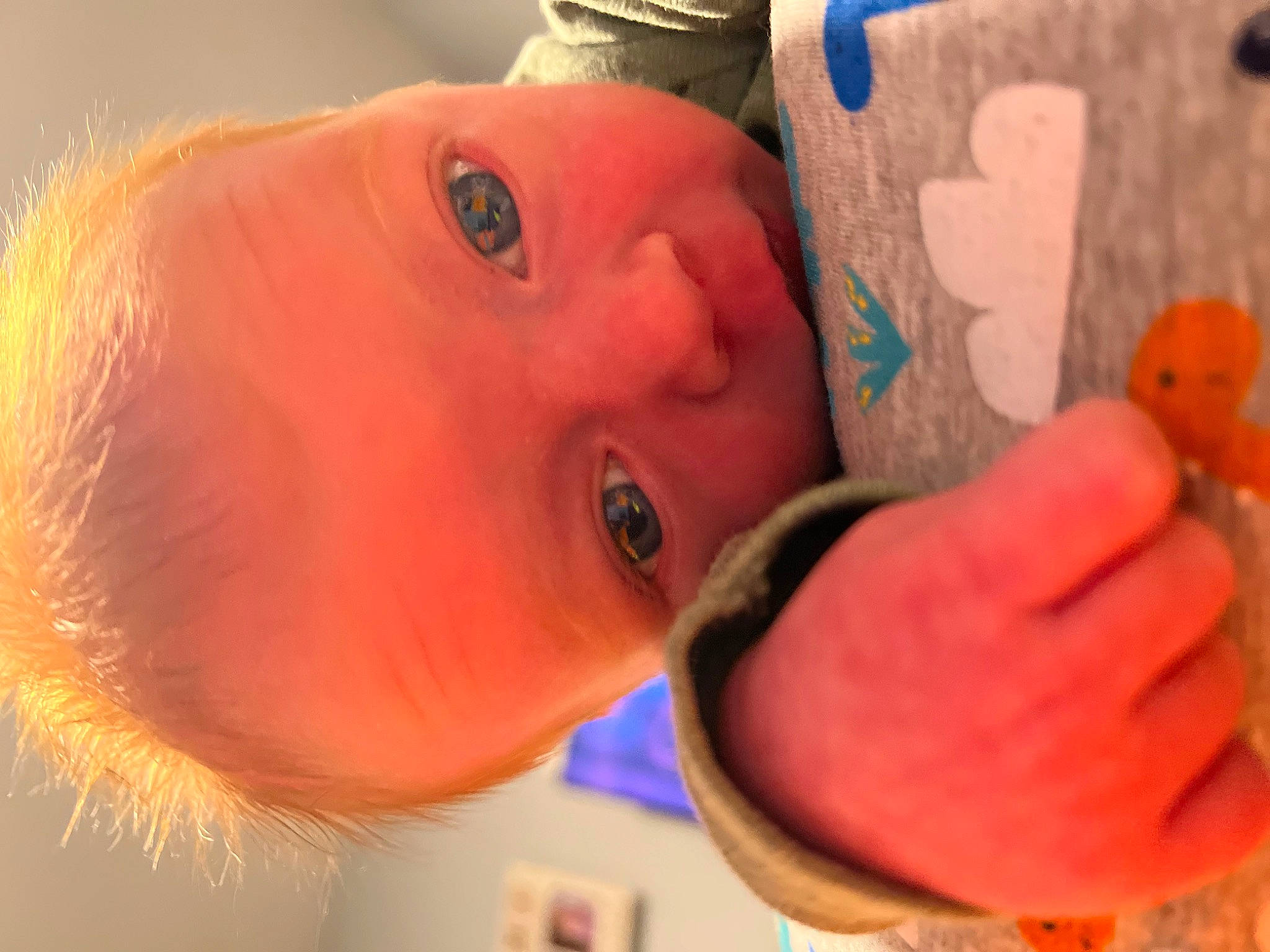 Ashton is registered to the contest to win money with this photo: baby, cheek, child, eyelash, facial_expression, finger, fun, gesture, happy, hat, lip, mouth, nose, orange, organ, person, skin, smile, thumb, toddler