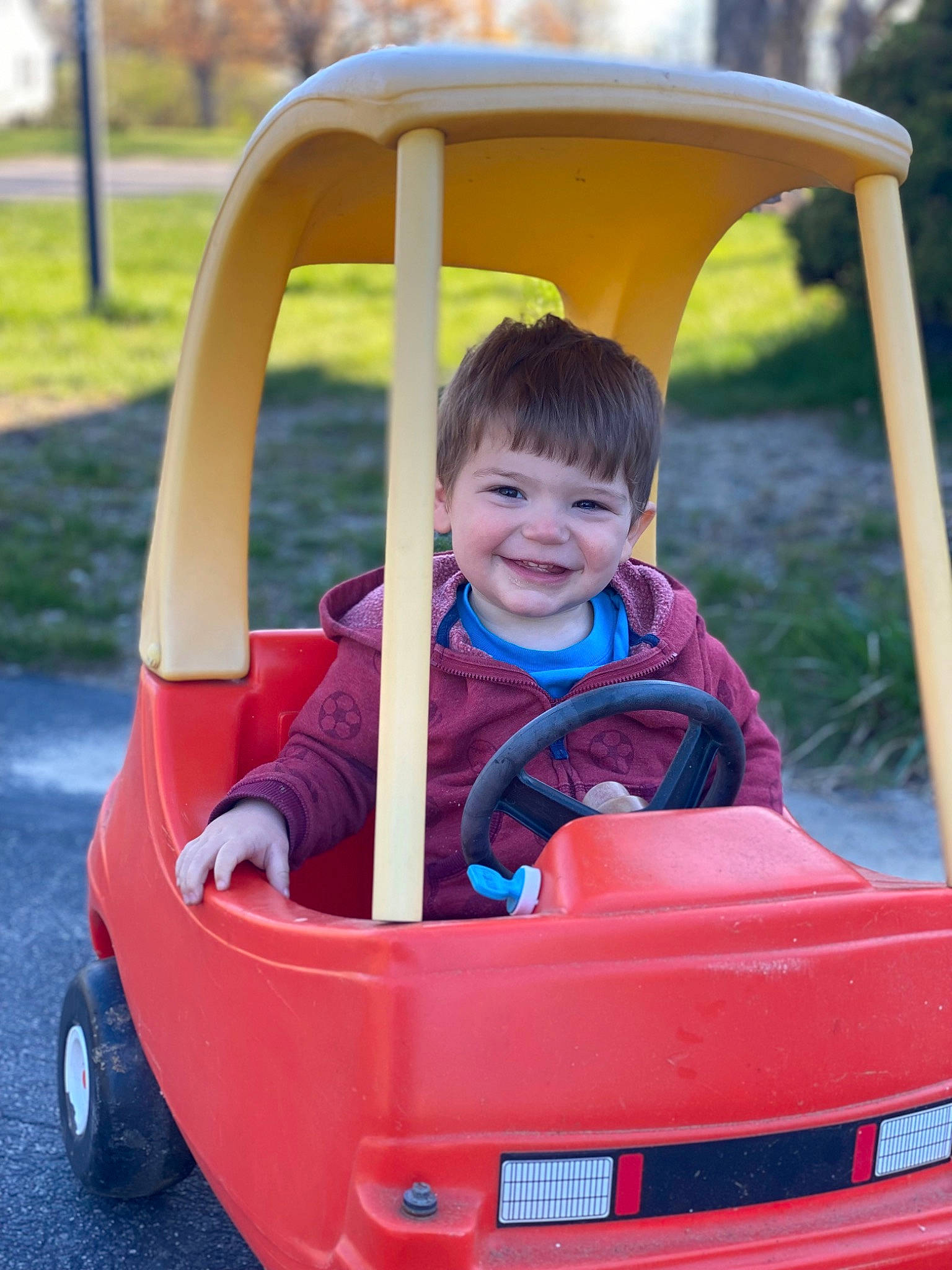 Marty joined the competition — help win amazing prizes! automotive_exterior, baby_toddler_clothing, fun, grass, joy, leisure, motor_vehicle, person, photograph, plant, product, public_space, recreation, red, riding_toy, smile, tire, toddler, travel, vehicle