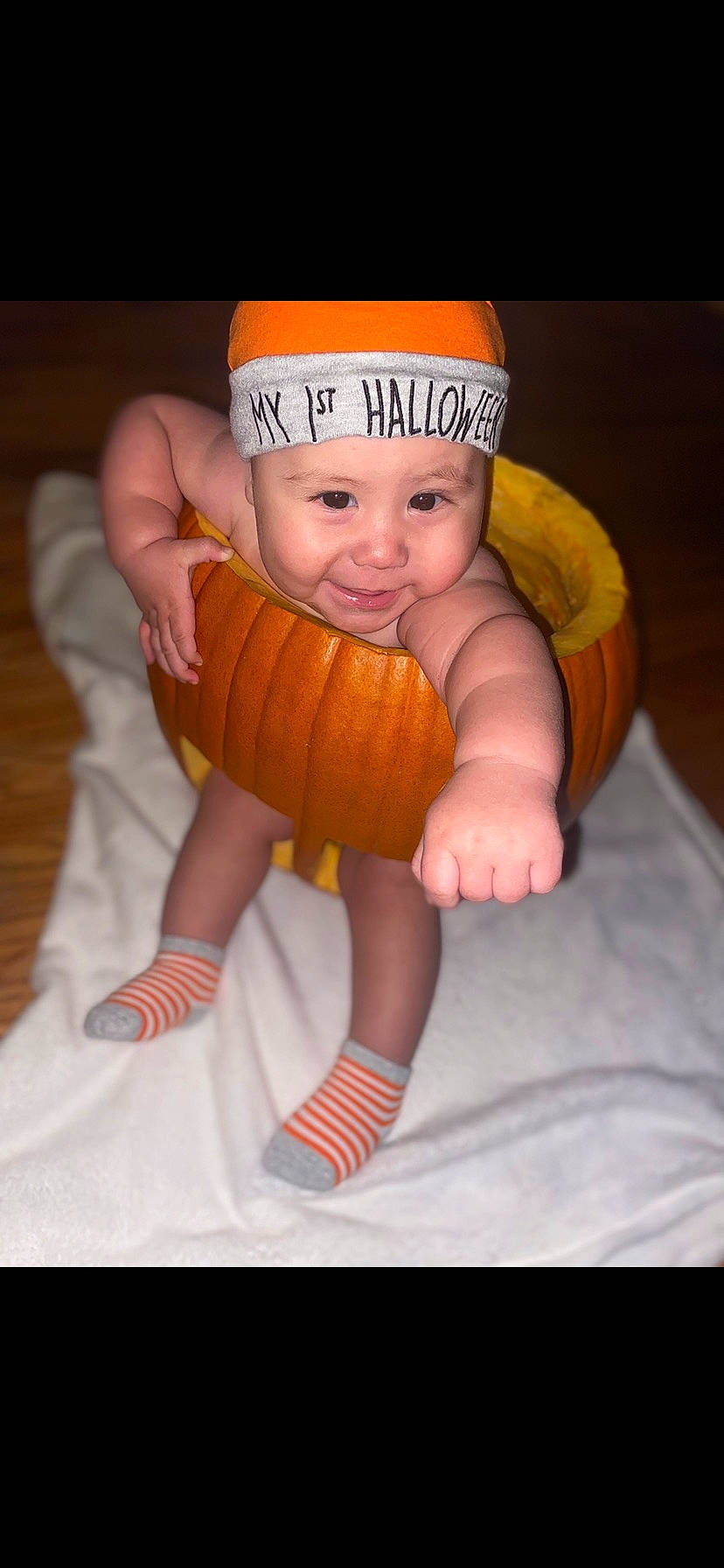 Kaydan is registered to the contest to win money with this photo: baby, baby_toddler_clothing, calabaza, cap, child, doll, dress, eye, happy, hat, head, headgear, headwear, human_body, joy, orange, person, pumpkin, stuffed_toy, thumb