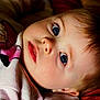 Lilia is registered to the contest to win money with this photo: baby, child, face, blue_eyes, close_up, infant, lying_down, soft_lighting, curly_hair, cute, innocence, cozy, portrait, skin, expression, toddler, clothing, person, head, sleepwear