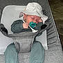 Waylon is registered to the contest to win money with this photo: baby, baseballcap, bodypart, bonnet, cap, chair, clothing, couch, cushion, face, finger, furniture, hand, hat, head, homedecor, pants, person, photography, portrait