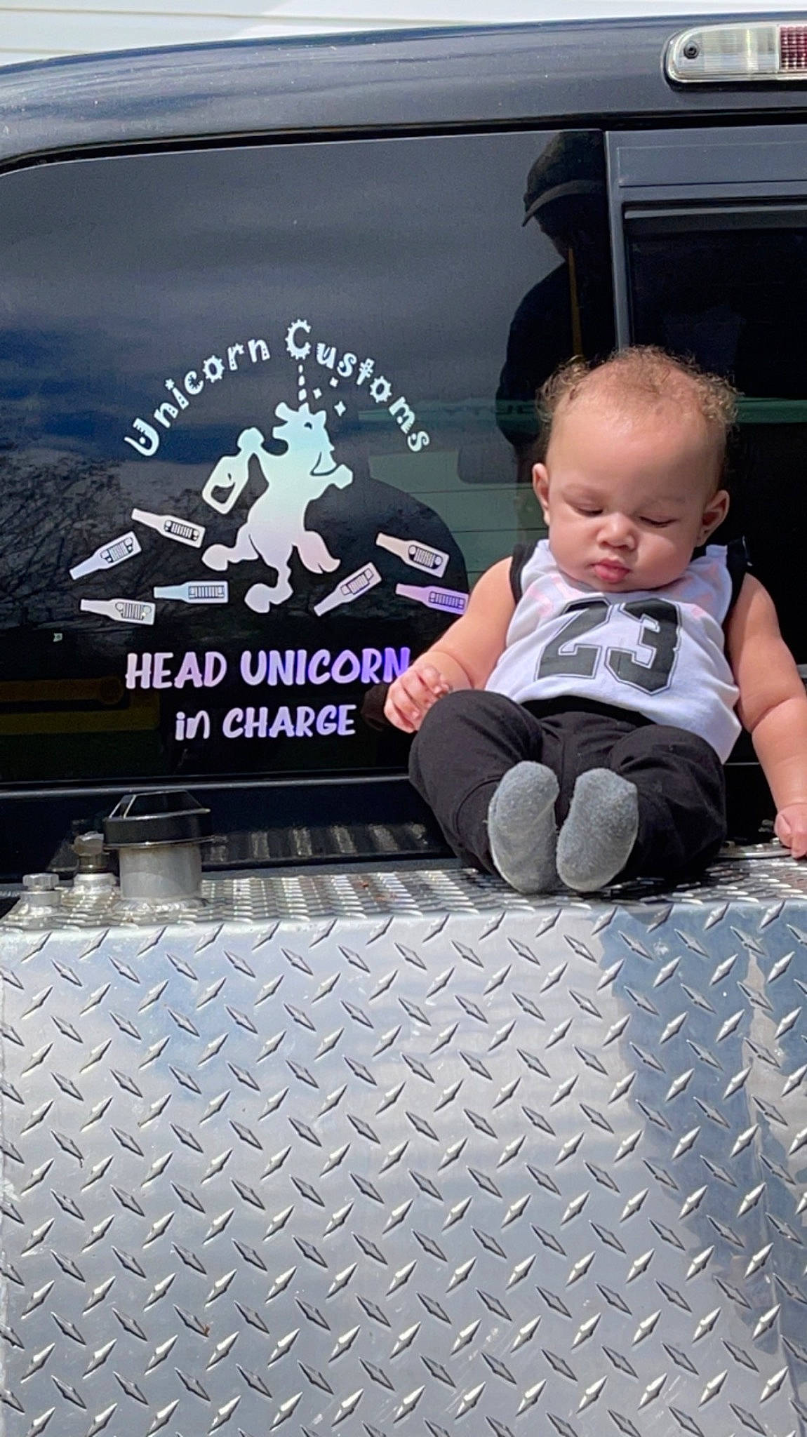 Dax is registered to the contest to win money with this photo: advertising, auto_part, automotive_design, automotive_exterior, automotive_lighting, baby, baby_toddler_clothing, bumper, child, family_car, flooring, font, graphics, hood, logo, luxury_vehicle, motor_vehicle, person, t_shirt, toddler