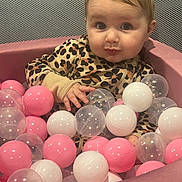 Giovanna joined the competition — help win amazing prizes! baby, child, ball_pit, pink_balls, white_balls, clear_balls, leopard_print, cute, indoor, playtime, infant, portrait, young_child, fun, toy, seated, curious, face, hand, soft_texture