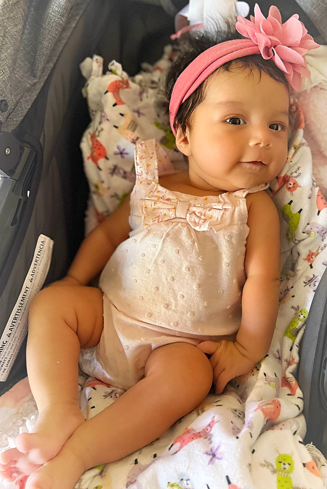 Cecilia is registered to the contest to win money with this photo: abdomen, baby, baby_toddler_clothing, blond, dress, eye, face, finger, foot, happy, headband, headgear, human_leg, knee, mouth, pattern, person, pink, skin, thigh