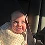 baby, child, car_seat, seat_belt, smile, blue_eyes, sunlight, shadow, bib, clothing, infant, cute, happy, sitting, portrait, car_interior, hand, face, young_child, sunlight_shadow
