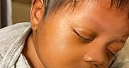 Dahari is registered to the contest to win money with this photo: arm, baby, butterfly, closeup, clothing, face, gray_shirt, hair, hand, indoors, infant, newborn, peaceful, person, portrait, resting, skin, sleeping, tattoo, toddler