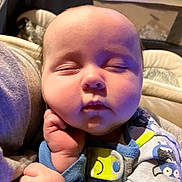 Daniel is registered to the contest to win money with this photo: baby, bed, blanket, bodypart, clothing, couch, cushion, face, finger, furniture, hand, head, homedecor, newborn, pants, person, photography, portrait, quilt, sleeping