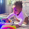Stevie joined the competition — help win amazing prizes! baby, child, toy, piano, colorful, indoor, curious, crawling, onesie, hand, face, playing, floor, purple_light, infant, young_child, closeup, focus, homedecor, carpet