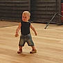 Marceau a rejoint le concours — aidez-le/la à gagner de superbes lots ! toddler, child, blonde_hair, black_top, denim_shorts, brown_sandals, wooden_floor, indoor, curious, standing, exploring, person, young_child, casual_clothing, shorts, footwear, fence, equipment, motion, light