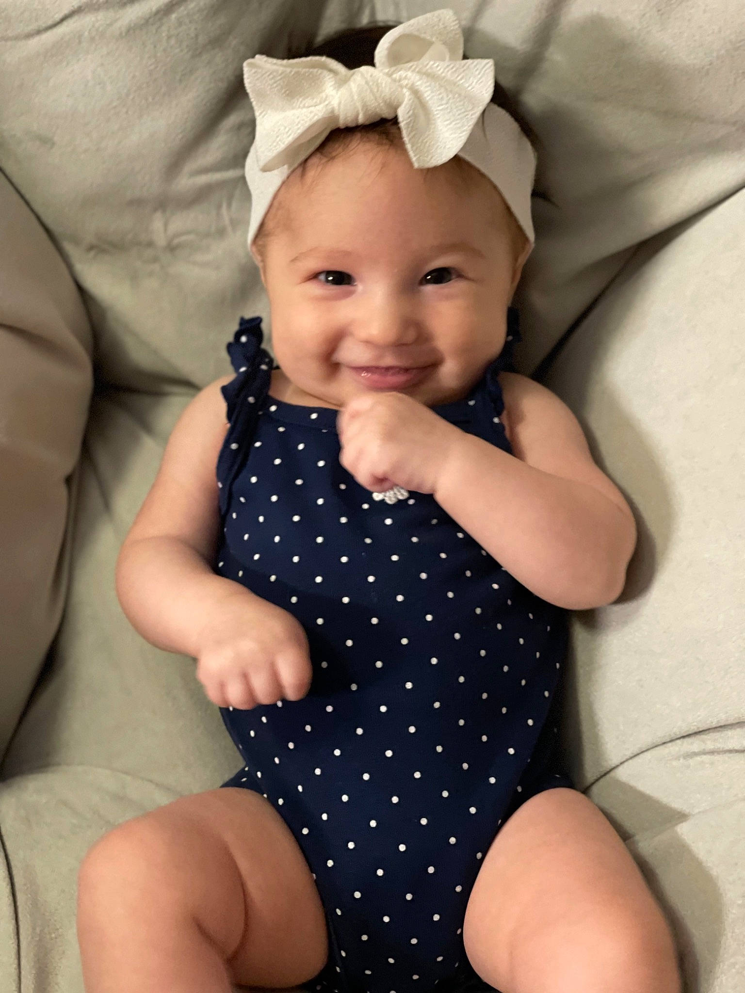 Ashley is registered to the contest to win money with this photo: arm, baby_toddler_clothing, clothing, dress, eye, face, finger, happy, head, headgear, iris, joy, lip, neck, one_piece_garment, organ, person, skin, sleeve, smile