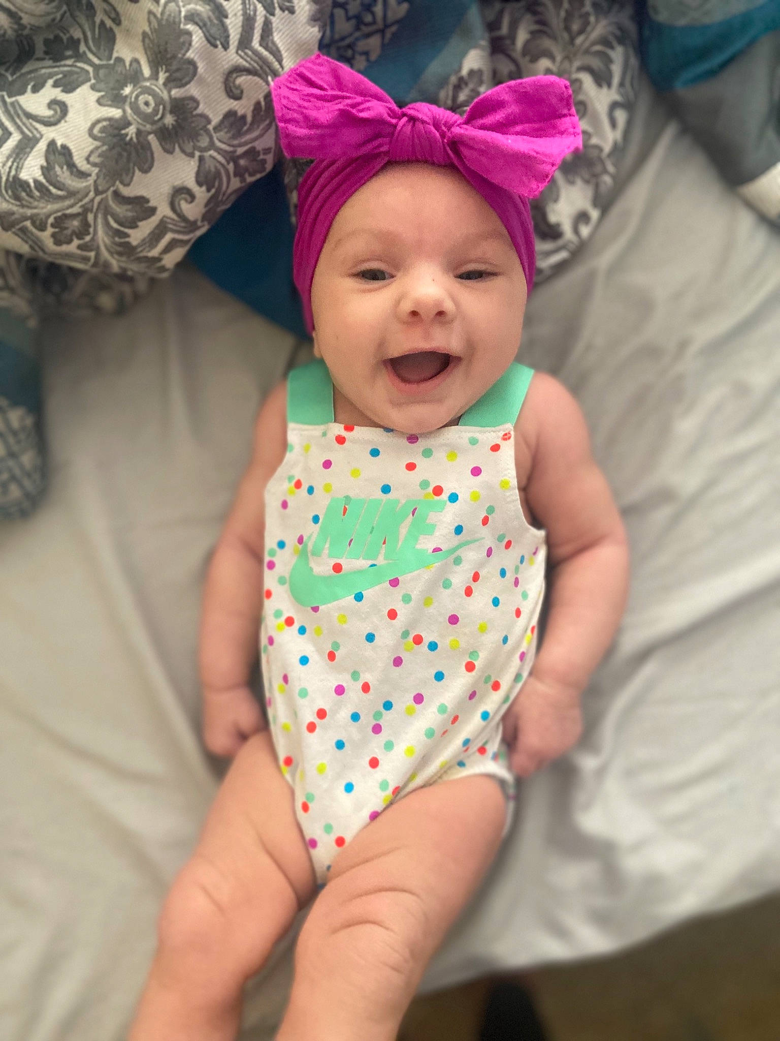 Meelah joined the competition — help win amazing prizes! baby, baby_toddler_clothing, child, comfort, dress, face, finger, fun, happy, headwear, infant_bodysuit, linens, magenta, pattern, person, pink, purple, skin, sleeve, smile