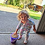 Lëandra a rejoint le concours — aidez-le/la à gagner de superbes lots ! barn, bucket, child, concrete, curly_hair, daytime, doorway, driveway, face, grains, grass, hand, looking_up, pajamas, playful, portrait, sneakers, surprised_expression, toddler, yard