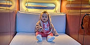 Cataleya participe au concours pour gagner de l'argent avec cette photo : baby, clothing, couch, cushion, face, footwear, furniture, head, homedecor, hosiery, indoors, person, photography, portrait, shoe, sitting, sneaker, sock, transportation, vehicle