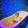 Cataleya a rejoint le concours — aidez-le/la à gagner de superbes lots ! toddler, bathtub, rubber_ducks, child, blue_wall, toy, indoor, cute, playful, pigtails, white_clothing, jeans, sneakers, floor_rug, portrait, colorful, fun, smiling, young_child, decor