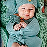 baby, infant, smiling, knitwear, hat, blanket, cozy, green, cute, child, feet, hands, portrait, indoors, soft, warm, happy, face, person, wrapped