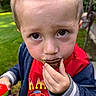 Caleb joined the competition — help win amazing prizes! child, toddler, portrait, close_up, face, eyes, blond_hair, smiling, eating, chocolate, cupcake, dessert, food, outdoor, garden, grass, red_shirt, jacket, hand, colorful