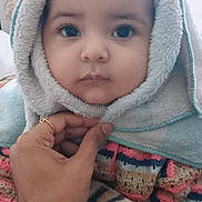 Hanvika is registered to the contest to win money with this photo: baby, child, face, hood, towel, hand, blanket, warm, cute, portrait, indoor, soft, expressionless, clothing, person, closeup, young, cozy, wrapped, comfort