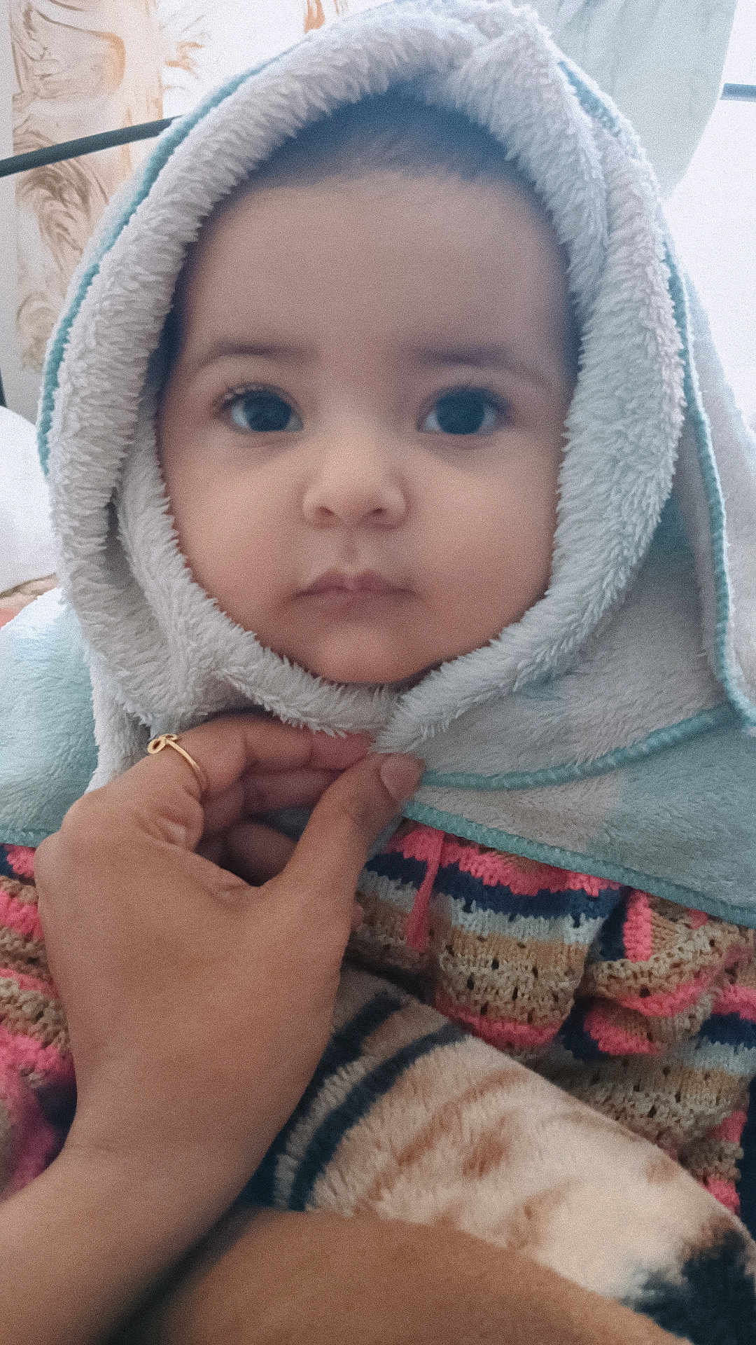 Hanvika is registered to the contest to win money with this photo: baby, child, face, hood, towel, hand, blanket, warm, cute, portrait, indoor, soft, expressionless, clothing, person, closeup, young, cozy, wrapped, comfort