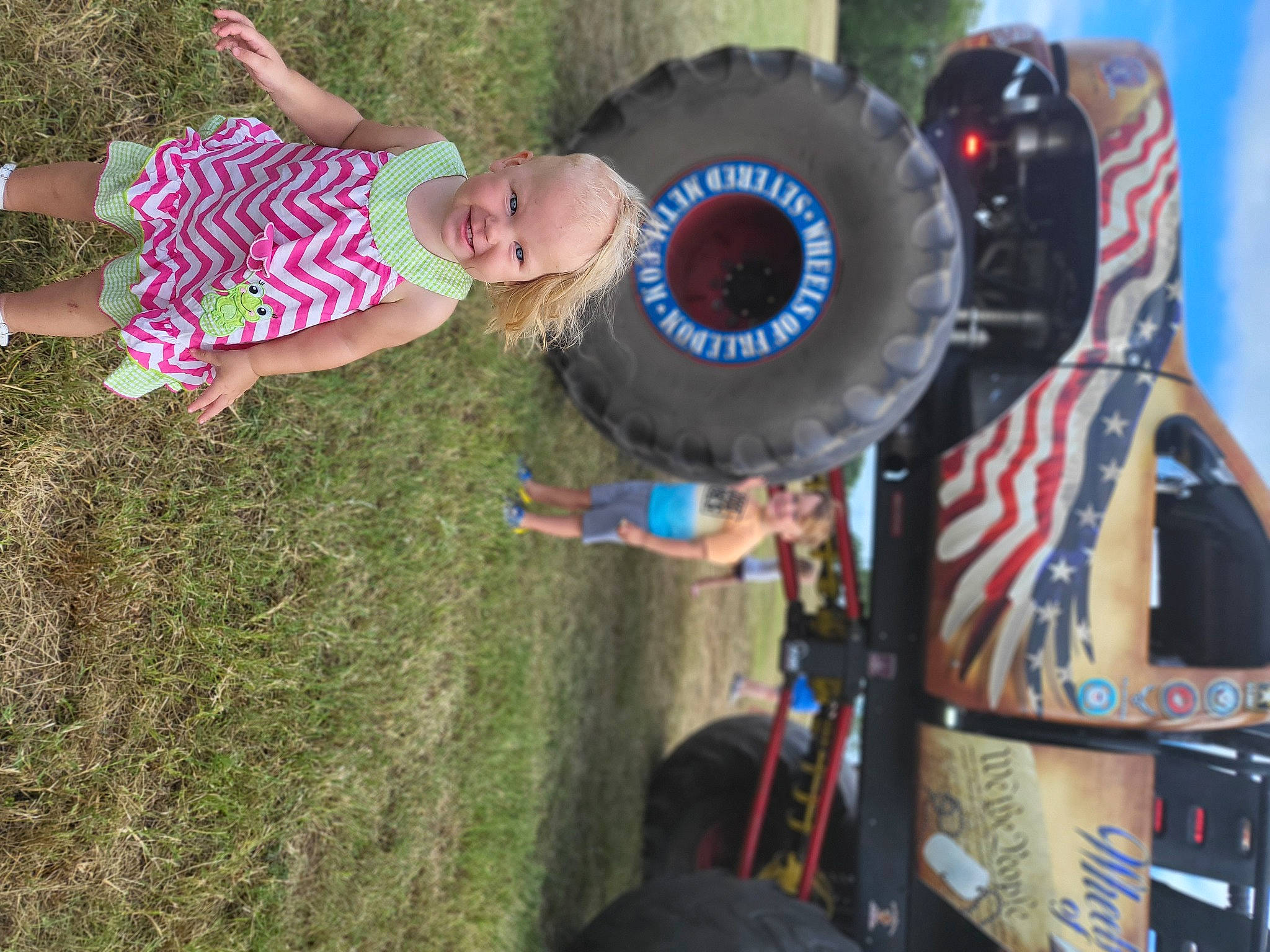 Avie is registered to the contest to win money with this photo: auto_part, automotive_tire, automotive_wheel_system, baby, blurred, drum, fun, grass, hat, joy, leisure, motor_vehicle, musical_instrument, person, plant, recreation, rim, t_shirt, tire, toddler
