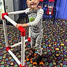 Zaidyn Wilkinson is registered to the contest to win money with this photo: child, roller_skates, walker, pajamas, smiling, indoor, colorful_carpet, vending_machine, playful, happy, boy, toy, fun, standing, patterned_floor, casual_clothing, young_child, recreation, leisure, bright