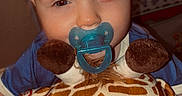Maximus joined the competition — help win amazing prizes! child, toddler, baby, pacifier, plush_toy, giraffe, stuffed_animal, portrait, close_up, smiling, blue_clothing, red_hair, indoor, nursery, toy, cuddly, cozy, face, sitting, photography