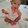 baby, bed, chair, child, cute, diaper, foot, furniture, hand, indoor, infant, pacifier, person, playful, room, sitting, smiling, television, toys, white_shirt