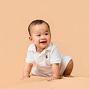 Rei joined the competition — help win amazing prizes! baby, crawling, smiling, white_clothing, polo_shirt, infant, child, cute, happy, studio, portrait, indoors, skin, face, head, hands, knees, beige_background, minimalist, soft_lighting