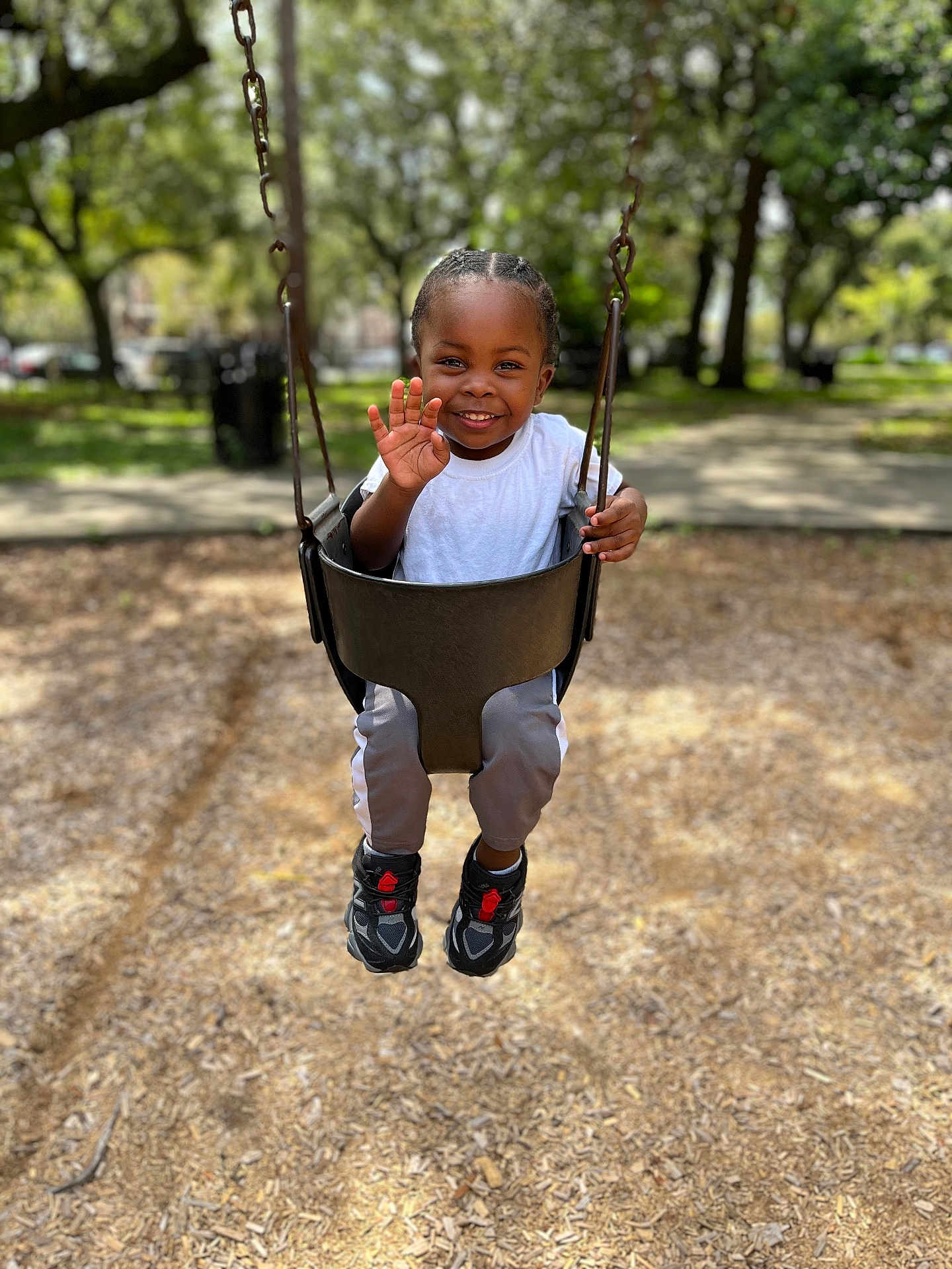 Kyren joined the competition — help win amazing prizes! child, swing, park, smile, happy, outdoor, playground, daylight, trees, grass, casual_clothing, white_shirt, sneakers, person, young, joy, fun, nature, activity, waving