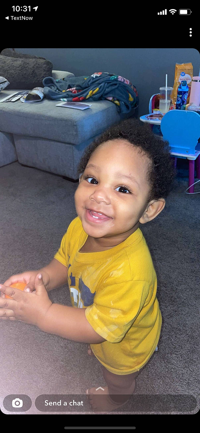 Antwain is registered to the contest to win money with this photo: blue, chair, cheek, child, chin, comfort, computer_keyboard, finger, flooring, fun, hairstyle, happy, joy, leisure, mouth, person, sitting, skin, smile, thumb