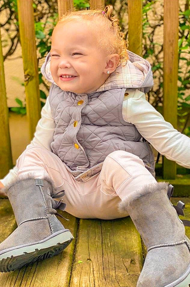 Kenzlee is registered to the contest to win money with this photo: baby, cheek, child, child_model, grass, joy, outerwear, person, plant, play, sitting, smile, toddler