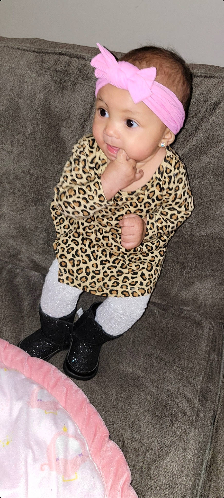 Draya is registered to the contest to win money with this photo: baby, baby_toddler_clothing, cap, flooring, foot, footwear, headgear, headwear, human_body, human_leg, knee, knit_cap, leg, pattern, person, pink, sleeve, sock, thigh, toddler