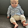 Soan a rejoint le concours — aidez-le/la à gagner de superbes lots ! baby, child, infant, striped_shirt, white_pants, couch, gray_couch, sitting, cute, smiling, face, feet, hand, blond_hair, indoors, portrait, young_child, comfortable, curious, casual_clothing