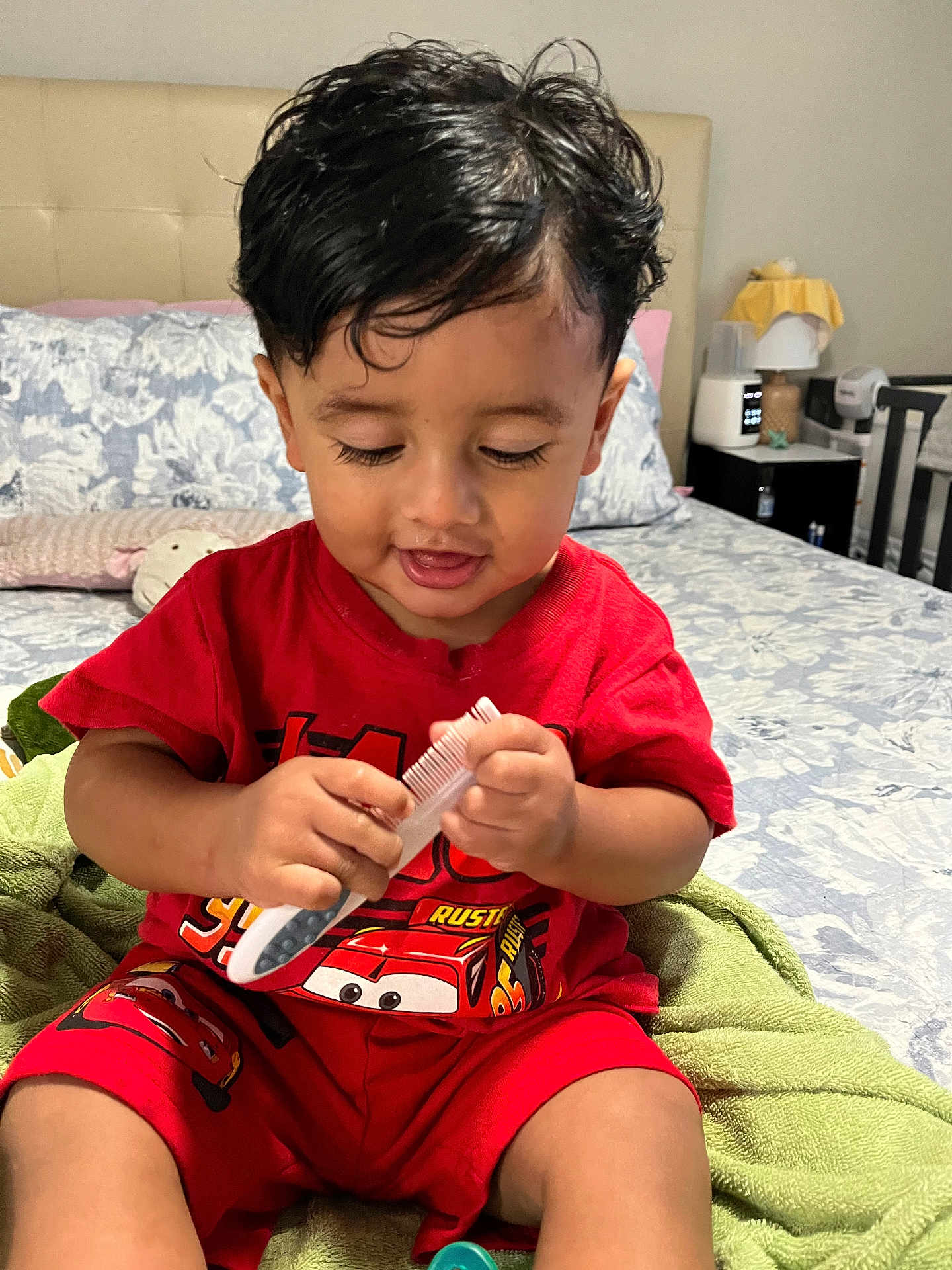 Matheo joined the competition — help win amazing prizes! toddler, child, red_clothing, comb, bed, blanket, indoor, furniture, smiling, hair, person, cute, playing, shorts, bedroom, toy, happy, young_child, casual, seated
