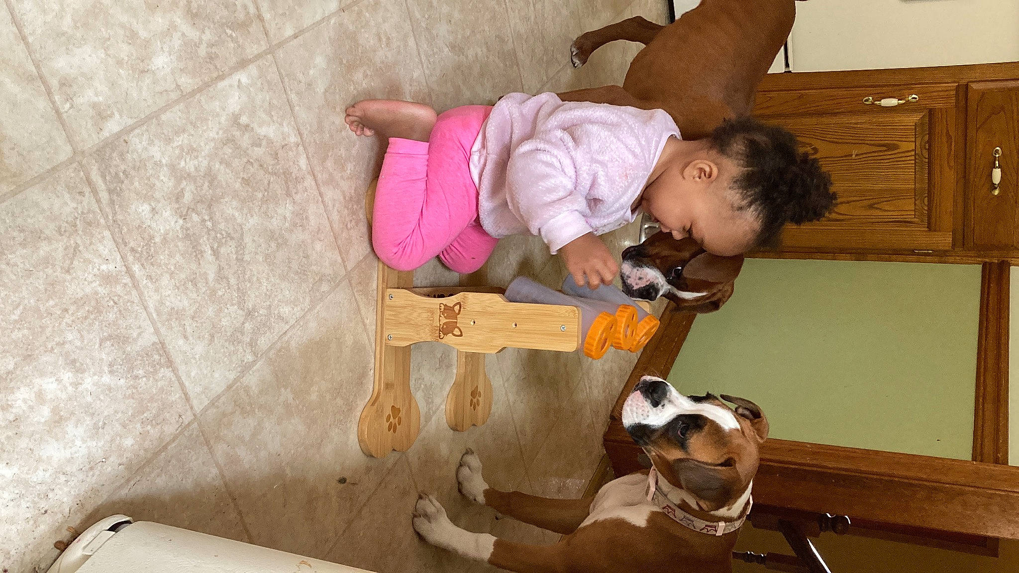 Laila Ali is registered to the contest to win money with this photo: baby, baby_products, baby_toddler_clothing, child, comfort, flooring, fun, happy, hardwood, knee, play, room, sandal, sitting, sock, toddler, wood